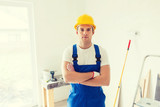 builder in hardhat with working tools indoors