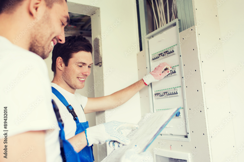 Obraz premium builders with clipboard and electrical panel