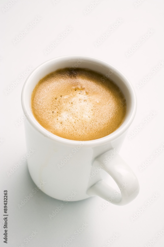 Cappuccino in a White Mug on a Saucer, White Background Cappuccino in a White Mug on a Saucer, White Background