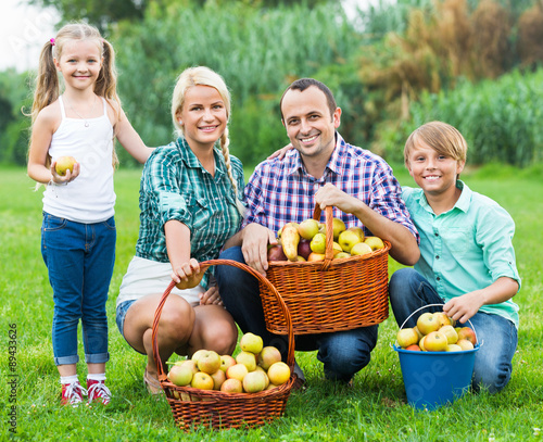 Happy parents and children with apples