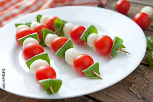 Mozzarella basil and tomatoes skewers on wooden sticks called