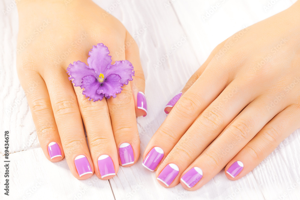 Fototapeta premium french manicure with violet flowers. spa