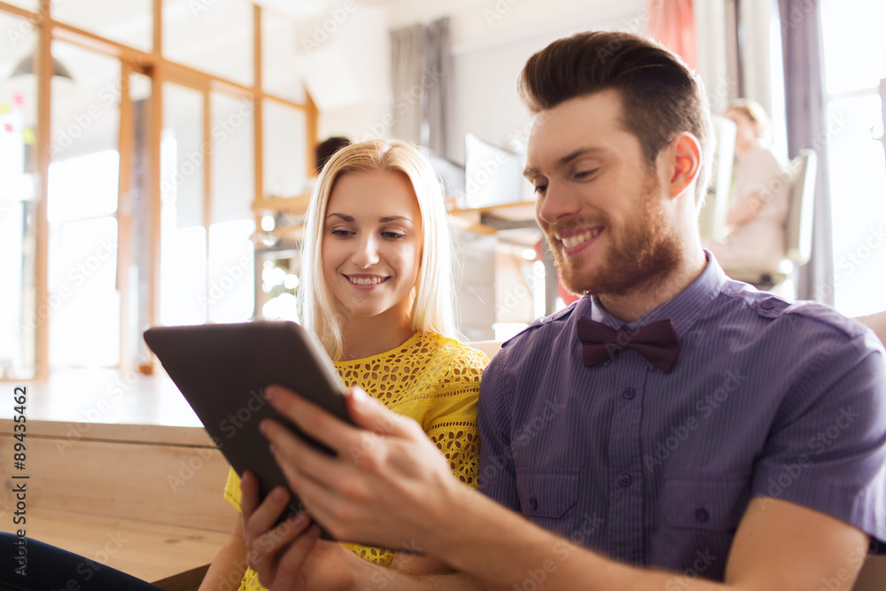 happy creative team with tablet pc in office happy creative team with tablet pc in office