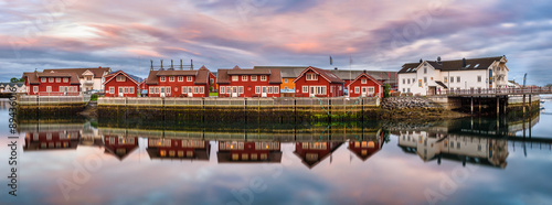 Red harbor houses in Svolvaer, Norway at sunset