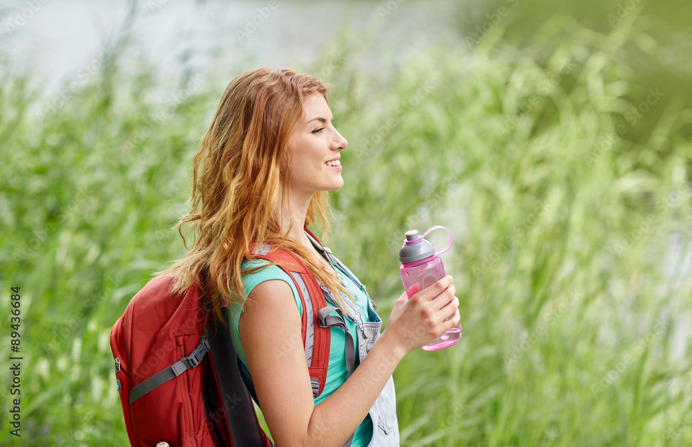 woman with backpack and bottle of water hiking woman with backpack and bottle of water hiking