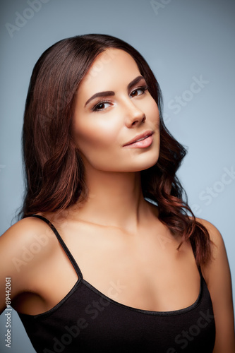 portrait of beautiful young woman in black tank top clothing, on