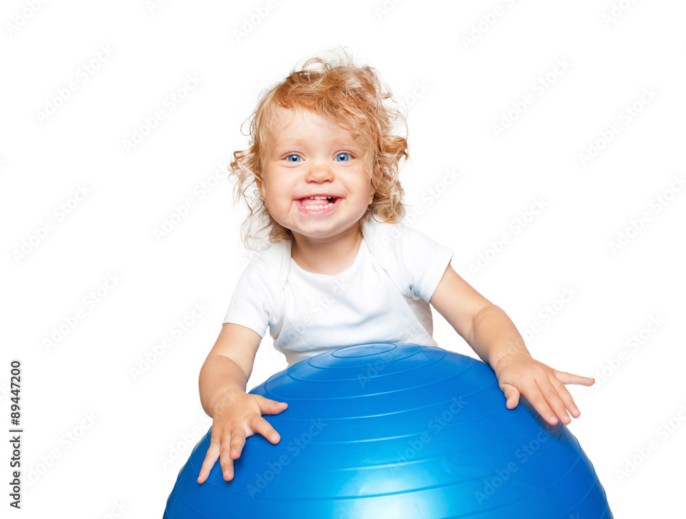 Smiling blond baby with gymnastic ball.