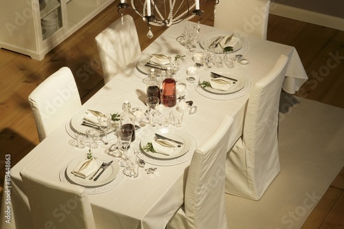 Christmas table laid in white photo