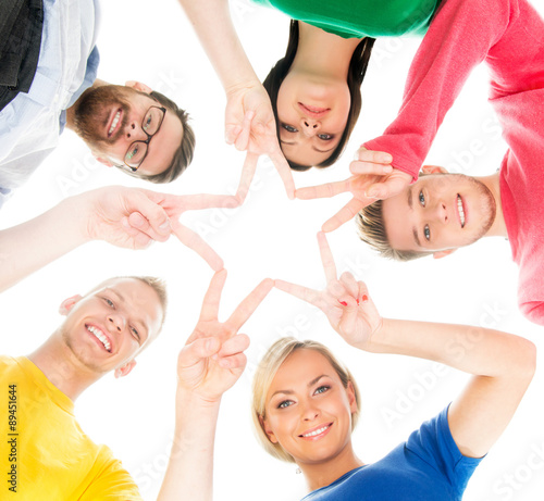 Happy students in colorful clothing standing together making star with their fingers.