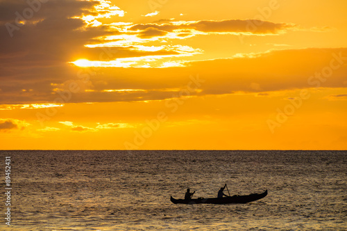 Canvas Print Two men paddling a Hawaiian outrigger canoe at sunset, Maui, Haw