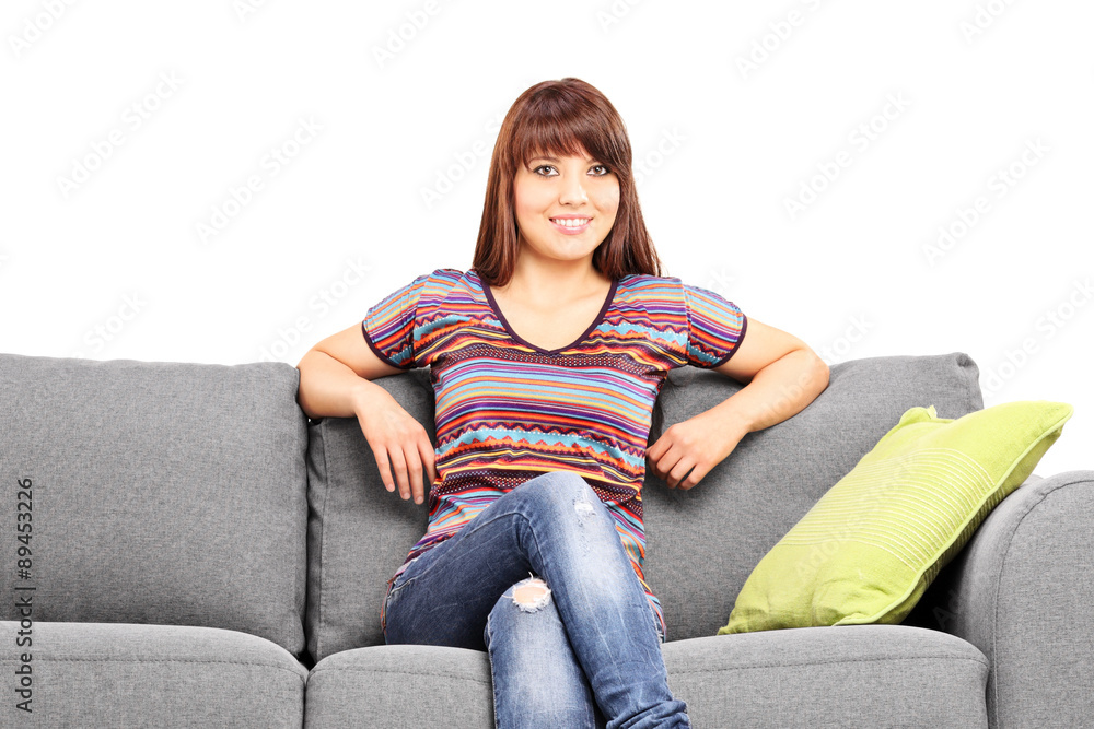 Relaxed woman sitting on a modern sofa Relaxed woman sitting on a modern sofa