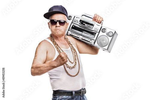 Mature man in hip-hop outfit holding a ghetto blaster