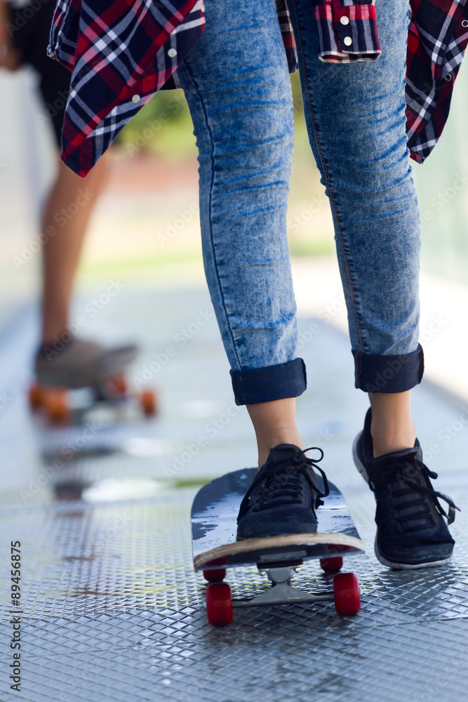 Young couple skateboarding in the street. Young couple skateboarding in the street.