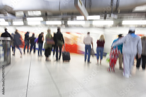 People standing and waiting in subway station, motion blur, zoom