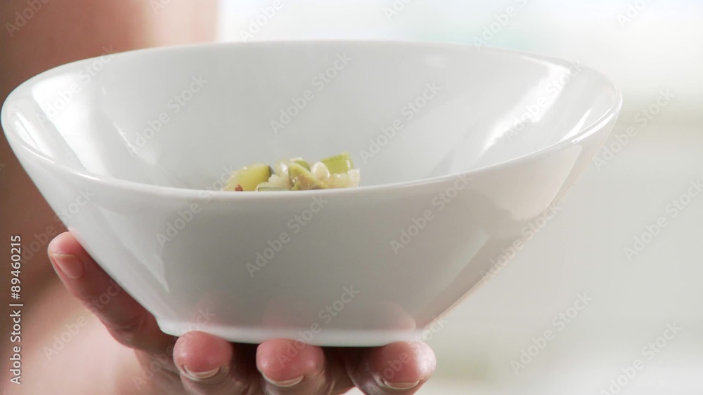 Minestrone being poured into soup bowls Minestrone being poured into soup bowls