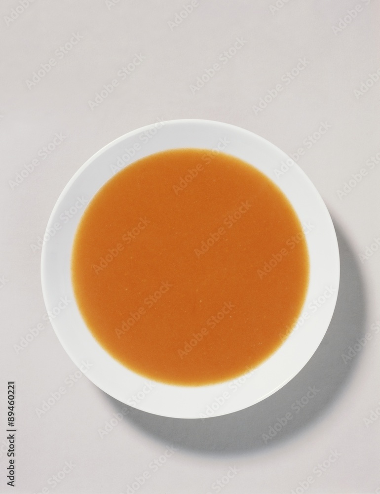 Tomato soup on white plate Tomato soup on white plate