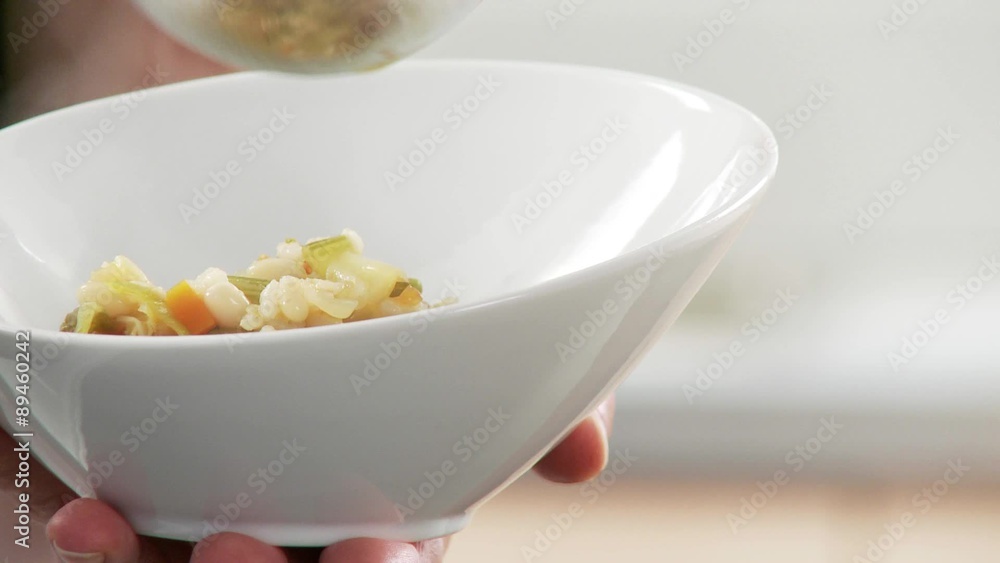 Minestrone being poured into soup bowls Minestrone being poured into soup bowls