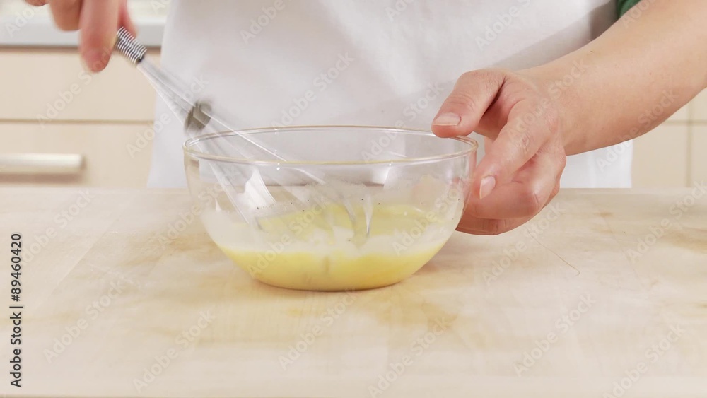 Egg yolk and cream being mixed together Egg yolk and cream being mixed together