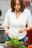 Young woman making salad
