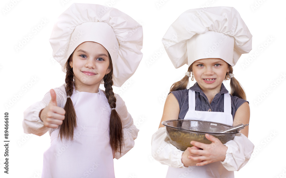 Cooking and people concept - Two Little girls in a white apron Cooking and people concept - Two Little girls in a white apron