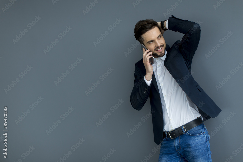Young man with mobile phone in the office Young man with mobile phone in the office