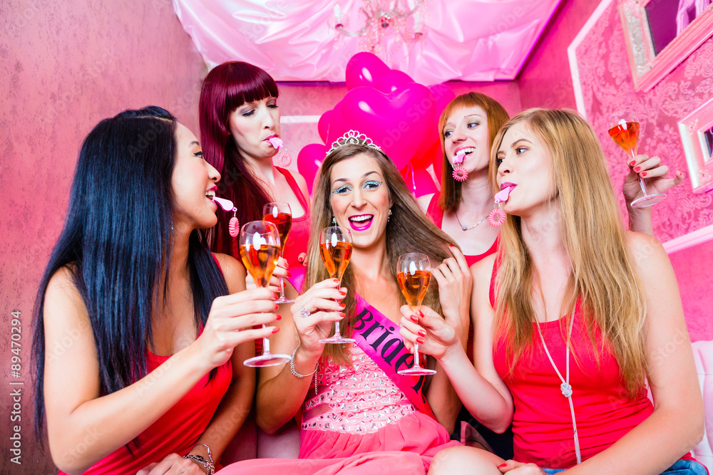 Bride and friends celebrating hen night with champagne and whistles in club