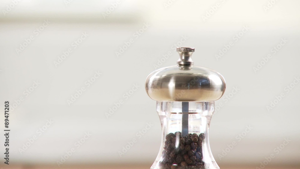 A hand taking gorgonzola and a pepper mill A hand taking gorgonzola and a pepper mill