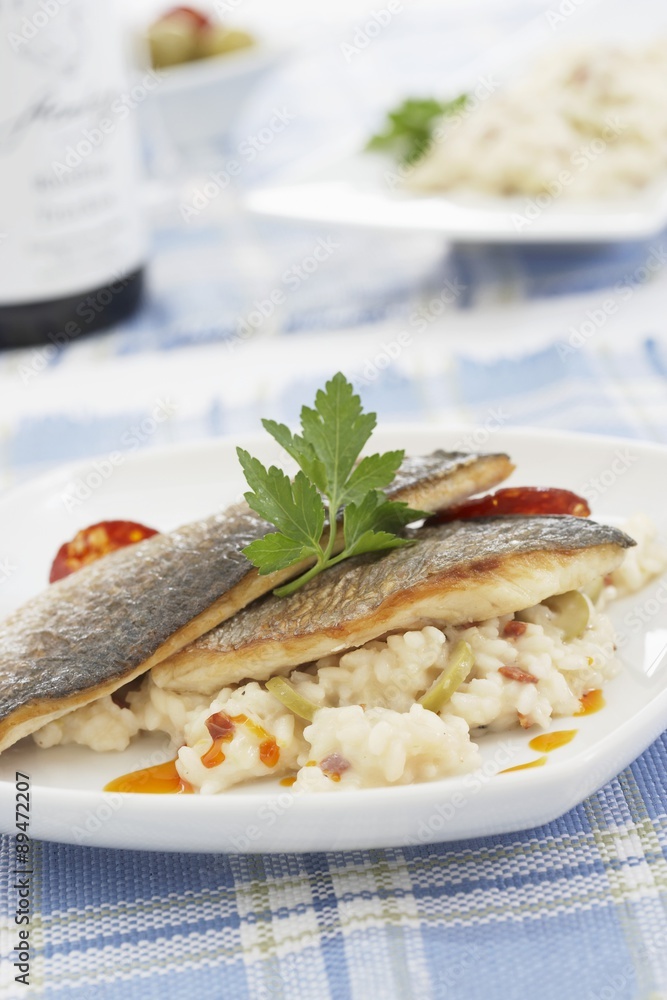 Fried sea bream fillets on risotto with chorizo Fried sea bream fillets on risotto with chorizo