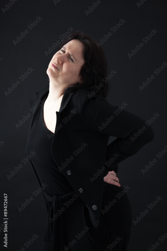 Beautiful woman doing different expressions in different sets of clothes: backache Beautiful woman doing different expressions in different sets of clothes: backache