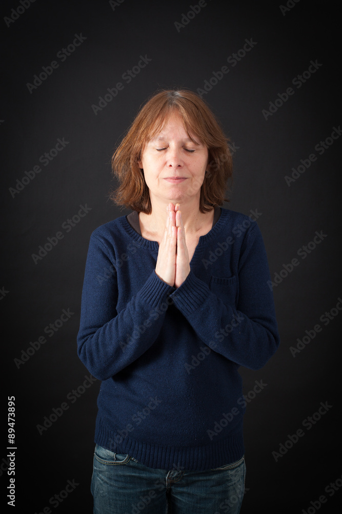 Beautiful woman doing different expressions in different sets of clothes: prayer Beautiful woman doing different expressions in different sets of clothes: prayer