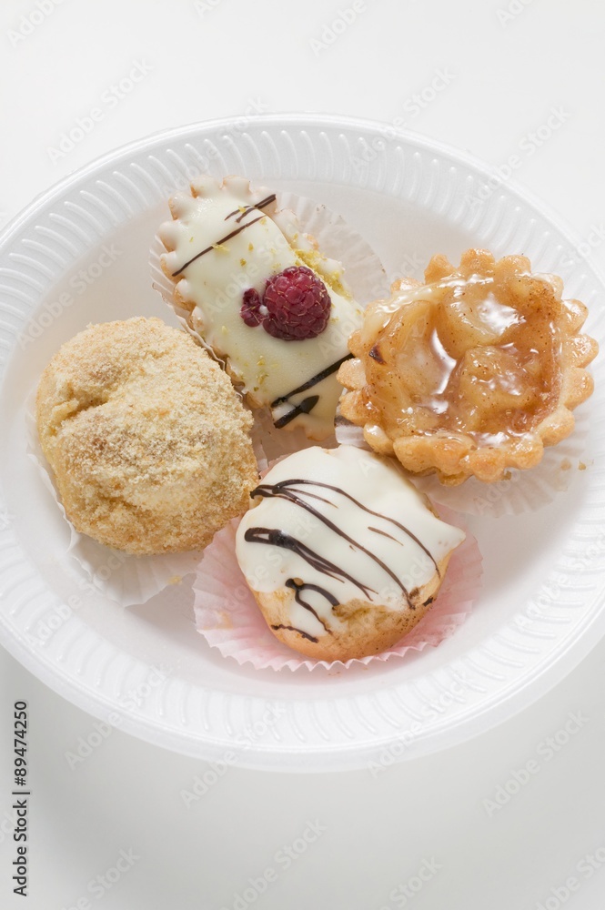 Assorted sweet pastries on plastic plate Assorted sweet pastries on plastic plate