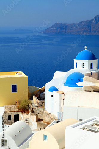 white and blue orthodox church in the village of Oia, Santorini