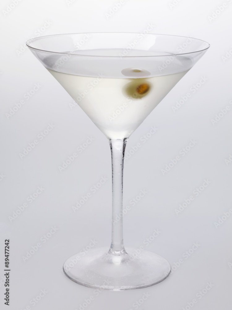 Martini with green olive in glass