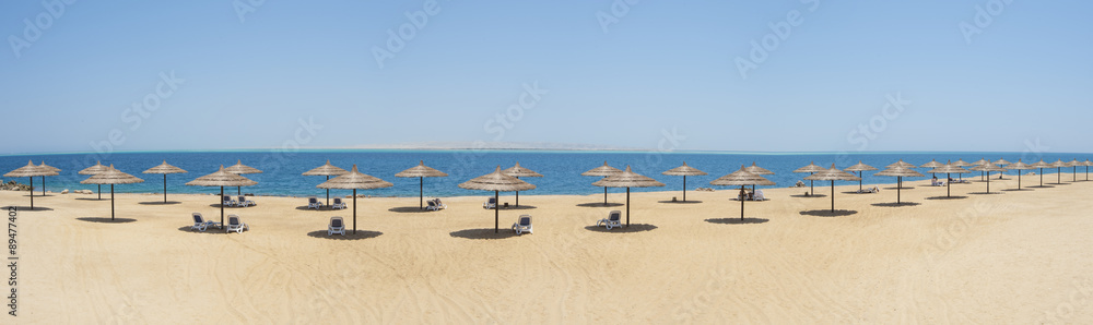Tropical beach with parasols