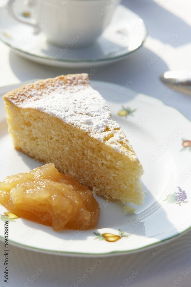 A piece of lemon cake with fruit compote A piece of lemon cake with fruit compote