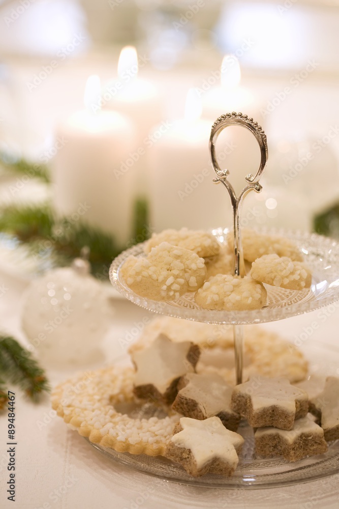 Biscuits on tiered stand on white Christmas table Biscuits on tiered stand on white Christmas table