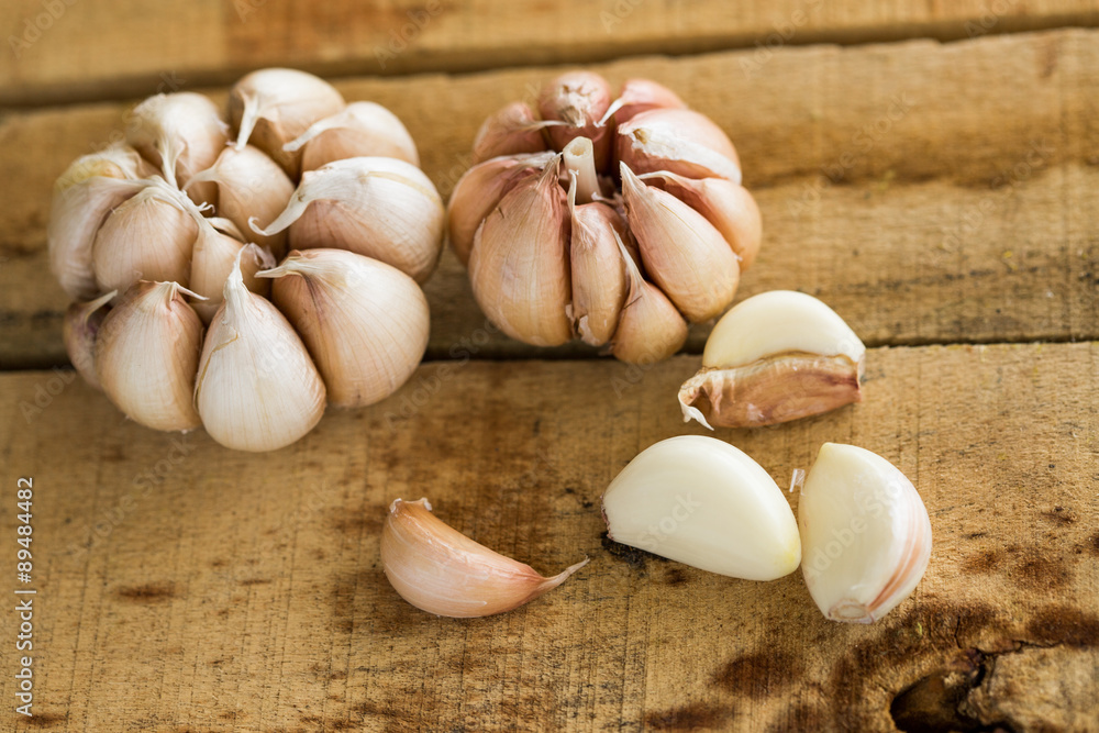 Garlic on the wooden background, Close up garlic on wooden table, Raw garlic in kitchen rooms. Garlic on the wooden background, Close up garlic on wooden table, Raw garlic in kitchen rooms.