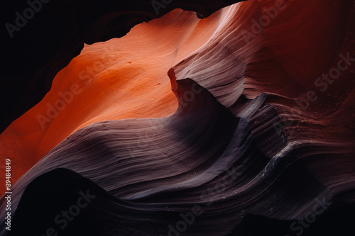 Sunlight waves over sandstone in a slot canyon
