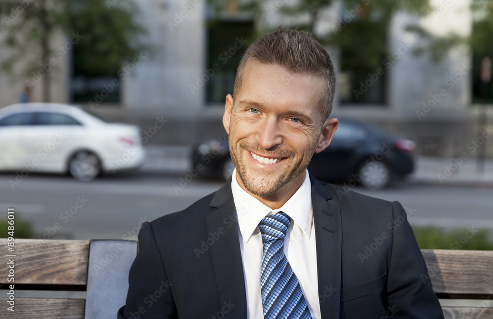 Mature Businessman Smiling At The Camera. He is outside of the office