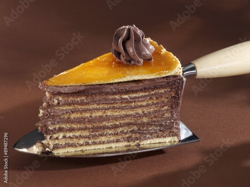 A piece of Dobos torte on a cake server