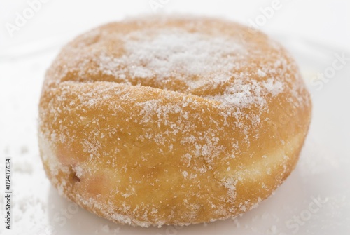 A sugared doughnut filled with jam