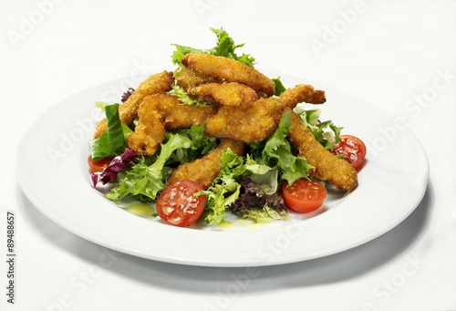 Salad leaves with breaded chicken fillets