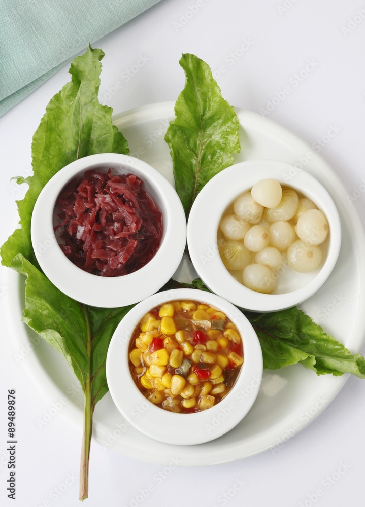 Red Cabbage, Pearl Onions and Corn and Red Peppers in Small White Bowls; From Above Red Cabbage, Pearl Onions and Corn and Red Peppers in Small White Bowls; From Above
