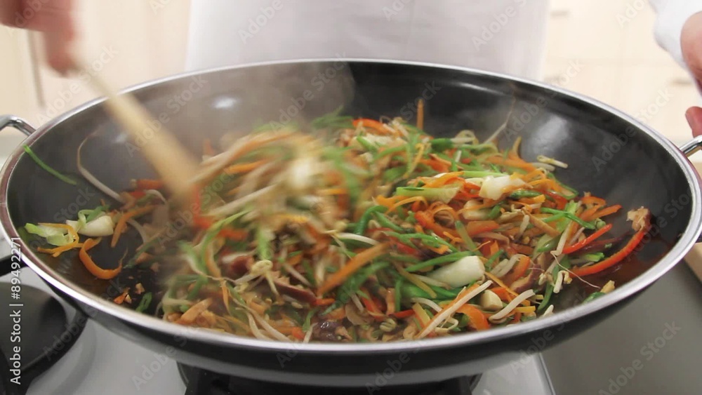 Stir-frying vegetables in a wok Stir-frying vegetables in a wok