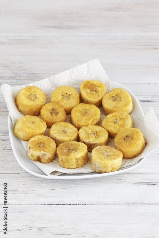 Fried plantain sliced drying on a kitchen paper Fried plantain sliced drying on a kitchen paper