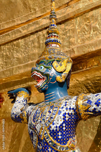 Guardian demon holding Golden Chedi of Wat Phra Kaew Temple in Bangkok, Thailand. © wasanajai