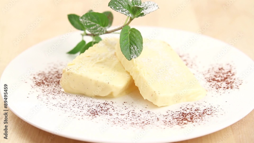 Vanilla parfait being dusted with icing sugar Vanilla parfait being dusted with icing sugar