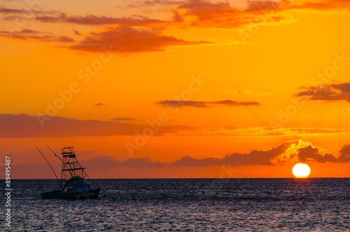 Beautiful sunset behind sport fishing boat on Maui, Hawaii, USA © Don Landwehrle