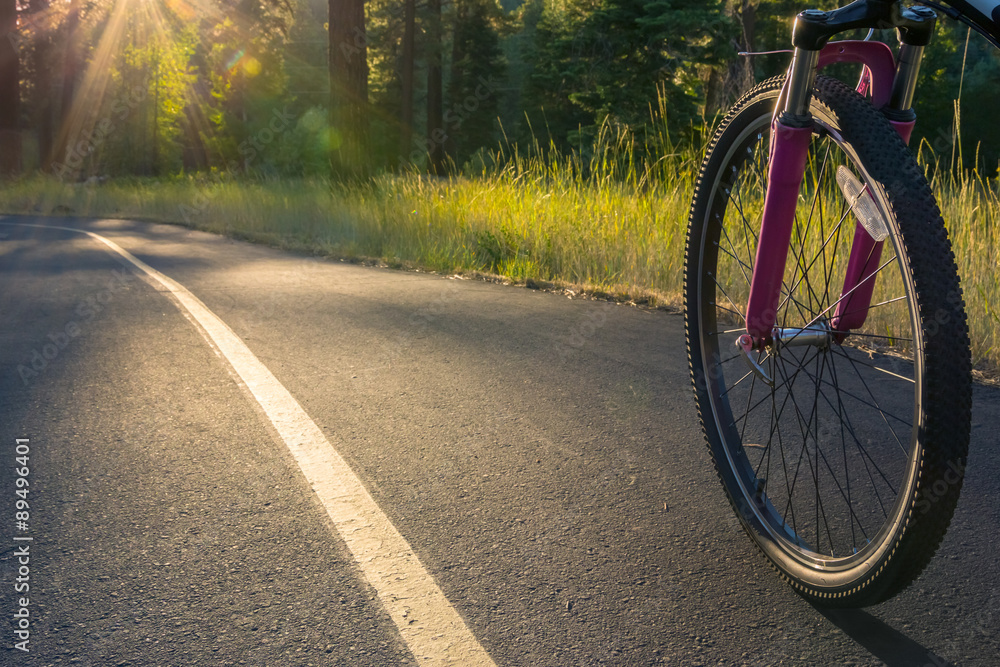 Bike on asphalt path illuminated by the sun. Bike on asphalt path illuminated by the sun.