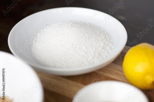 Sugar in a bowl, lemon